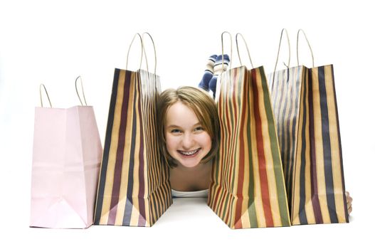 Happy teenage girl with lots of shopping bags