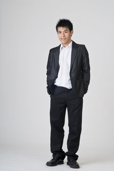 Immature young businessman, full length portrait of Asian office man.