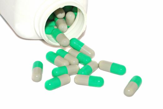 Green pills isolated on the white. 