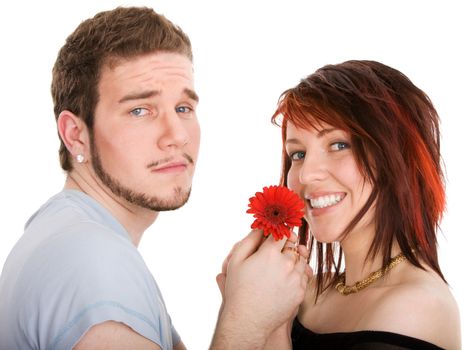 Young man with flower and pretty girl on isolated background