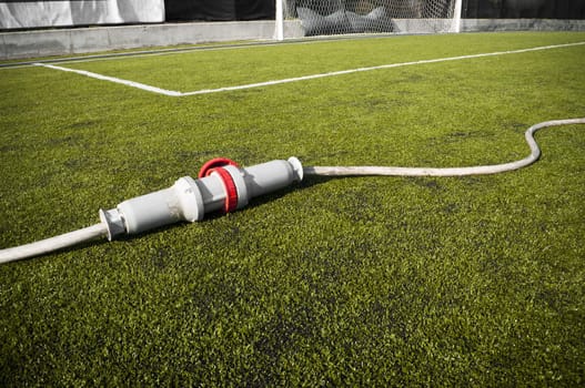 Connected wire in a soccer field on grass