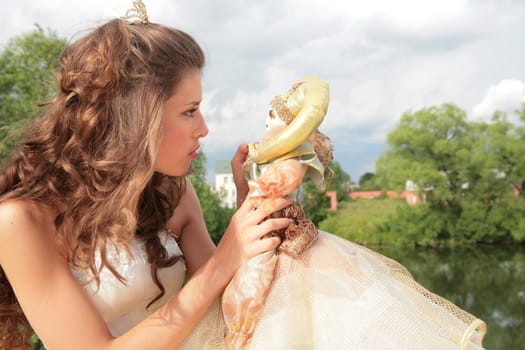 attractive girl in wedding white-golden gown says good-bye to childhood
