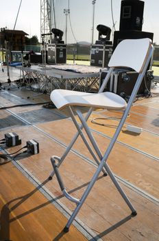 Chair on a wooden stage before a concert