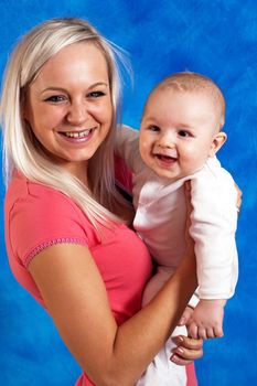 Mother smile to her child on the blue mosaic background