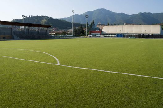 Little town soccer field stadium in plastic grass