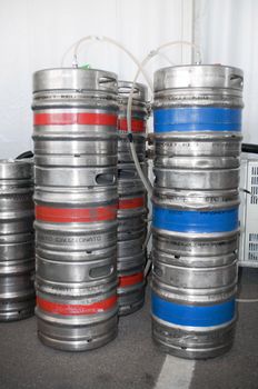 Steel indutrial barrels of beer stocked in storage