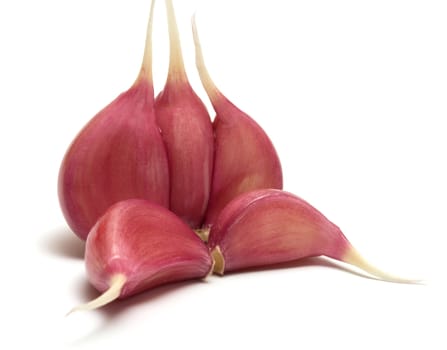 Garlic segments close up on a white background.