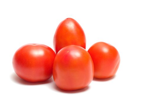 Four red tomatoes on a white background.