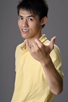 Young man with greeting gesture, closeup portrait of Asian.