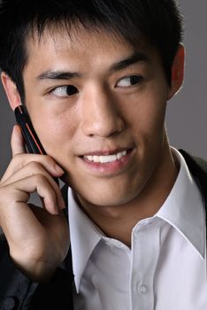 Happy young businessman use phone, closeup portrait of Asian office man.