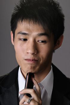 Closeup portrait of young businessman thinking with joyful expression on face.