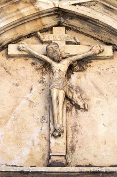 Detail of the ancient roman relief - crucified Jesus Christ - from 1342. Parish church of Saint Mark the Evangelist, Lirovel, Moravia, Czech republic.