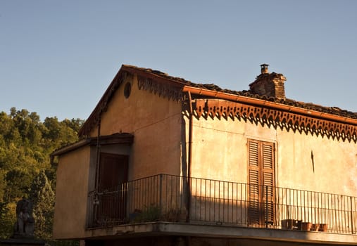 Old balcony struck by the rays of the setting sun