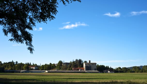 Agricultural fields and farm illuminated by the setting sun
