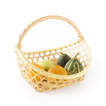 Pumpkins in a basket on a white background