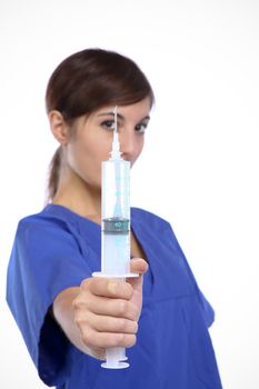 Conceptual Photo Of A Young Pretty Nurse Holding A Syringe