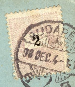 detail of vintage grungy postage stamp on blue postcard