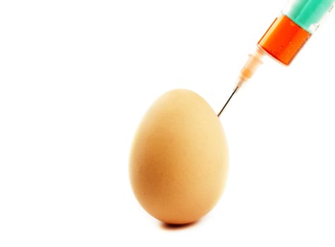 one egg gets injection from a syringe