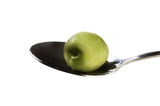 one green olive on a spoon isolated on white background