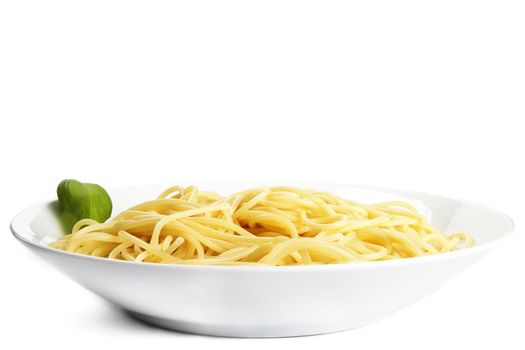 some pasta on a plate with basil on white background