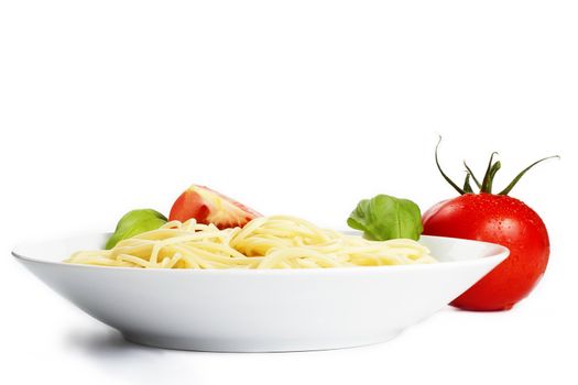 spaghetti in a plate with tomato and basil