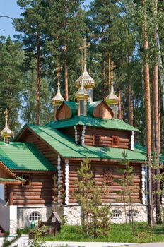 Wooden orthodox church among the pine trees in Russia, Urals