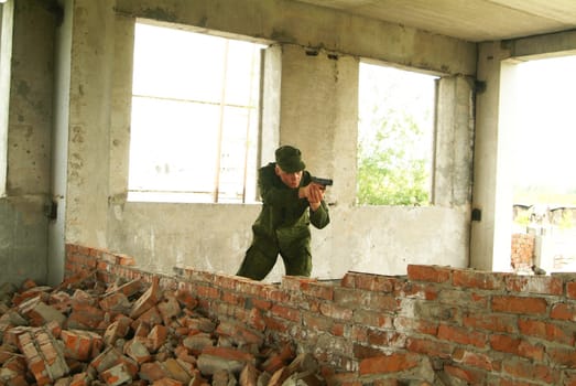 The soldier with a pistol performs antiterrorist operation.
