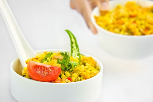 Decorating delicious food of rice and salad in beautiful bowl  