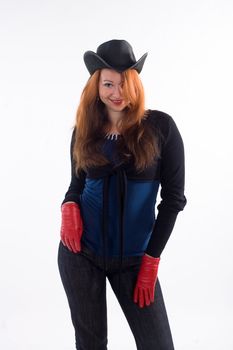 Young girl with red gloves and black hat standing on white background
