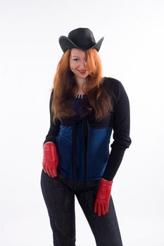 Young girl with red gloves and black hat standing on white background
