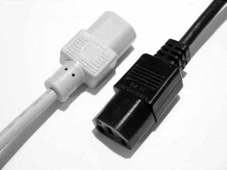 A black and a white computer power plug.