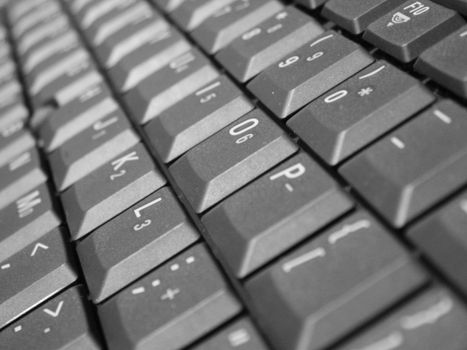 A distance shot of some keys on a laptop keyboard.