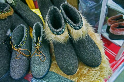 Traditional Russian felted shoes on shelf