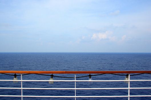 An ocean view from the side of a cruise ship.