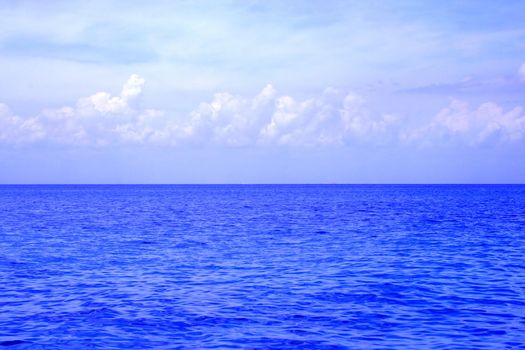 An ocean view from a cruise ship.  The sky is nice and cloudy.