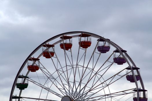 A ferris wheel against a cloudy sky