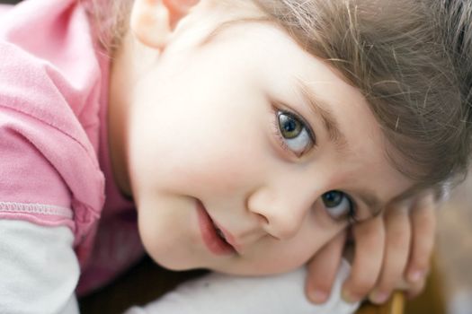 playful little girl, lying on her hands