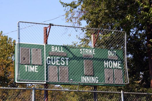 An old baseball scoreboard at a public park ballfiled.