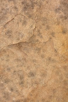 background of a flat red sandstone with dark spots