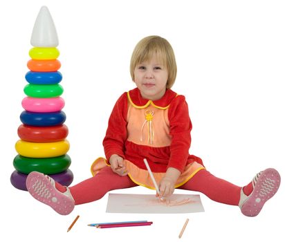 Little girl and crayons and toy plastic pyramid