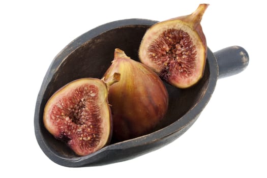 fresh Turkish figs on a rustic, wooden scoop, isolated on white, whole fruits and cross sections