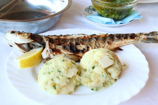 Roasted fish with potatoes in Croatian restaurant