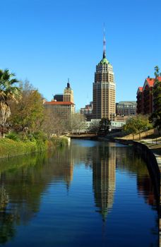 a riverwalk reflection of a tower in the San Antonio skyline