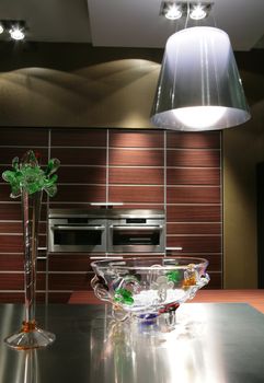 glass vases on shining metallic surface in interior of the modern kitchen