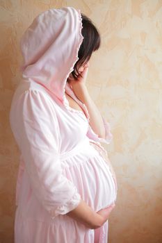 expectant mother in soft robe, morning near window
