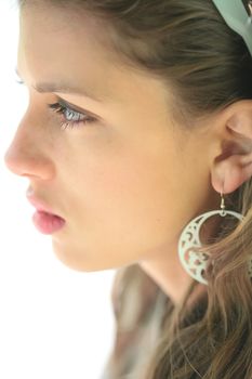 close-up portrait of the young beautiful woman with silver earring, profile