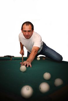 Smiling man playing billiards. Green table, White background