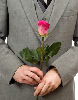 Closeup view of a man wearing a suit holding a rose