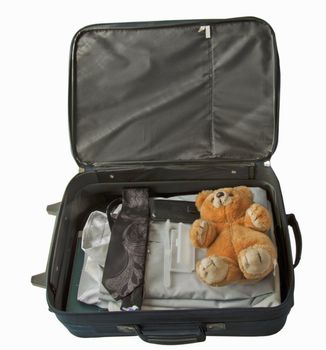 Suitcase of a man, with tie and shirt, with Teddy bear