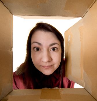 Female portrait through  cardboard box on white